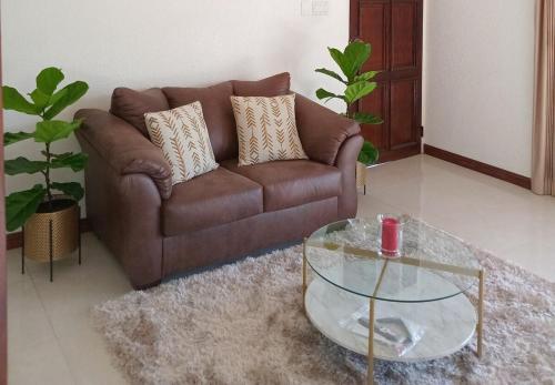 a living room with a couch and a glass table at Gorgeous 1 Bedroom Apartment in the Kingston Hills in Kingston