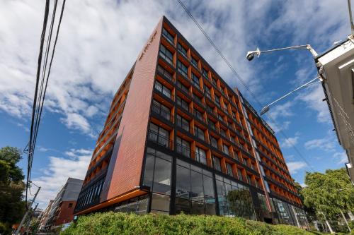 a tall red building with glass windows at Edificio Taj 97 By Jalo in Bogotá