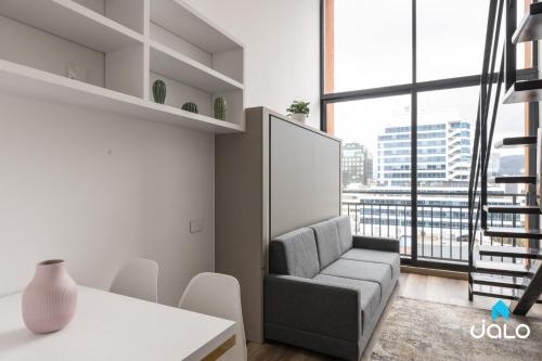 a living room with a couch and a large window at Edificio Taj 97 By Jalo in Bogotá