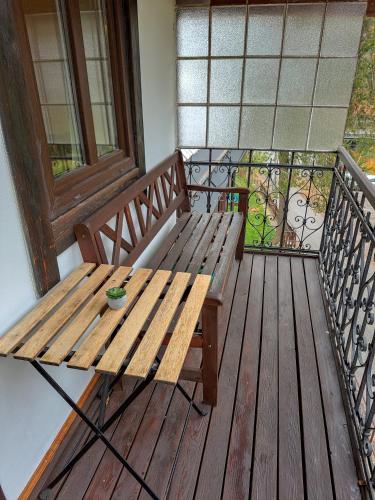 a wooden bench sitting on top of a balcony at Penzion Betlém in Janske Lazne
