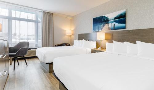 Un ou plusieurs lits dans un hébergement de l'établissement Repotel Henri IV Québec