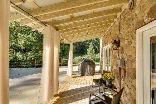 a porch with a wooden roof and a stone wall at Pet-Friendly Hickory Vacation Rental with Fire Pit! in Hickory
