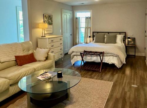 a living room with a bed and a coffee table at 8 min to UGA NEW Lake Loft Apt near downtown Athens at UGA free wifi and coffee in Athens