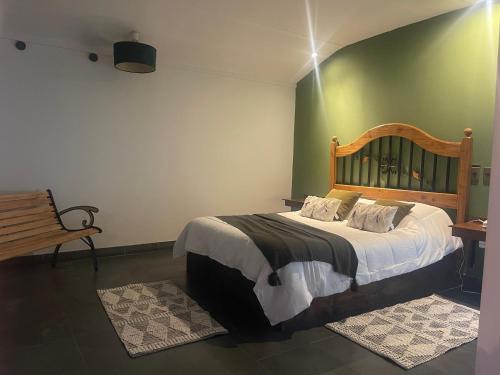 a bedroom with a large bed with a wooden headboard at Complejo turístico de la vita in Punta Arenas