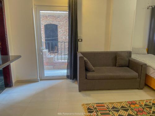 a living room with a couch and a balcony at Nile Panorama Hotel in Luxor