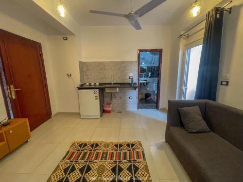 a living room with a couch and a kitchen at Nile Panorama Hotel in Luxor