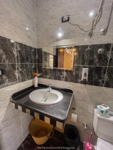 a bathroom with a sink and a toilet at Nile Panorama Hotel in Luxor