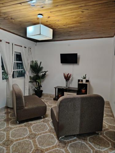 a living room with a couch and a chair at Hospedaje Namasol in La Quiaca