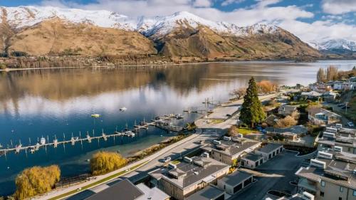 an aerial view of a town on a lake with mountains at Lakeview Luxury Villa in Wanaka