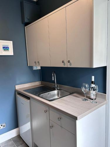 a kitchen with a sink and a counter top at Art Deco One Bedroom Guest Apartment in Yapton