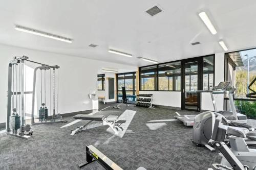 a gym with several exercise equipment in a room at Lakeview Luxury 2 Bedroom Villa in Wanaka