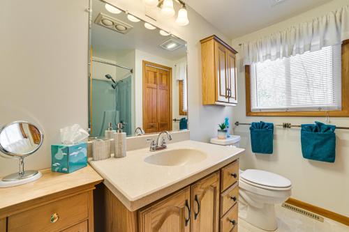 a bathroom with a sink and a toilet and a mirror at Boyne City Retreat Near Beaches and Mtn Resort! in Boyne City