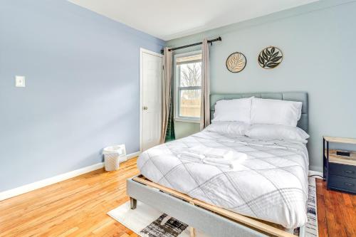 a bedroom with a bed and a window at 1 Mi to Rouge Park Home with Fenced Yard and Deck in Detroit