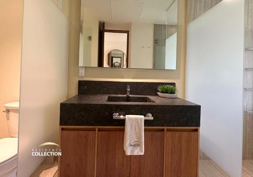 a bathroom with a sink and a mirror at Residence by Mio Nuevo Vallarta 103-C in Nuevo Vallarta