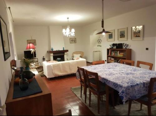a living room with a table and a couch at Equinoxea in Nazaré