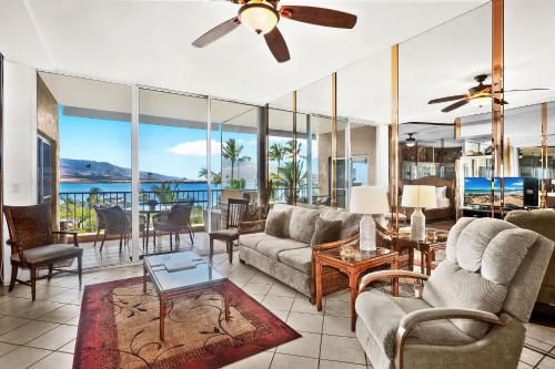 a living room with a couch and a ceiling fan at Menehune Shores 606 in Kihei