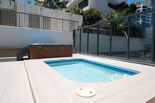a swimming pool in the middle of a building at High Level 1BR Apartment 1 MIN to Beach in Gold Coast
