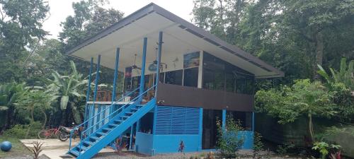 a house with a blue staircase leading up to it at Ocean View Modern Dream House 1 in Pavones