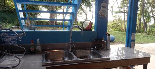 a kitchen sink with a view of a window at Ocean View Modern Dream House 1 in Pavones
