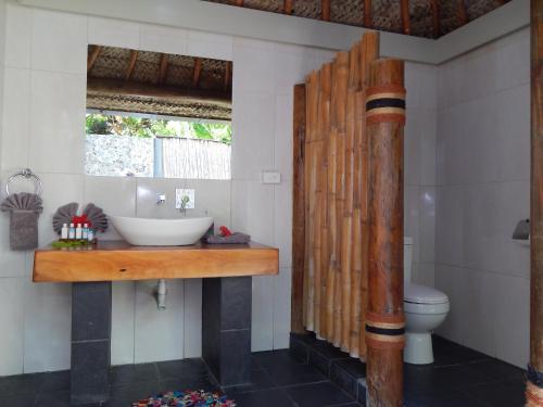 a bathroom with a sink and a toilet at Octopus Resort in Nalauwaki
