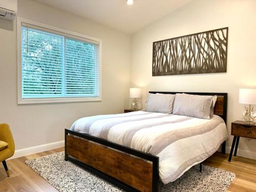 a bedroom with a large bed and a window at Chic and Petite 1-Bedroom ADU with Private Entrance in peaceful Orinda in Orinda