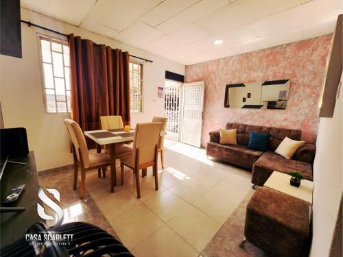 a living room with a table and a couch at Casa Scarlett in Cartagena de Indias