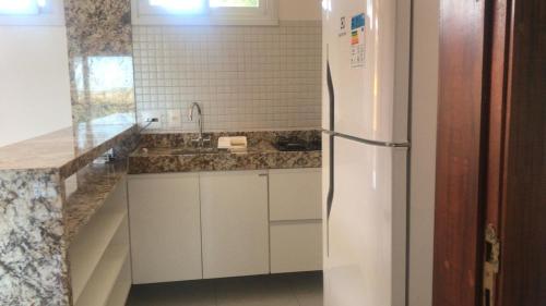 a kitchen with a refrigerator and a sink at Laguna verde residence in Aquiraz