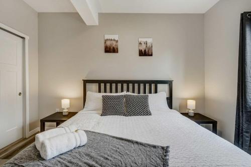 a bedroom with a large bed with two night stands at Parkside Ridge Cozy Escape w Hot Tub & Views in Monument