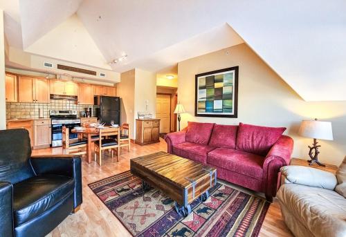 a living room with a red couch and a table at Heron Point by StayIn in Invermere