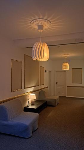 a living room with two couches and two lights at Vila PANORAMIC Busteni in Buşteni
