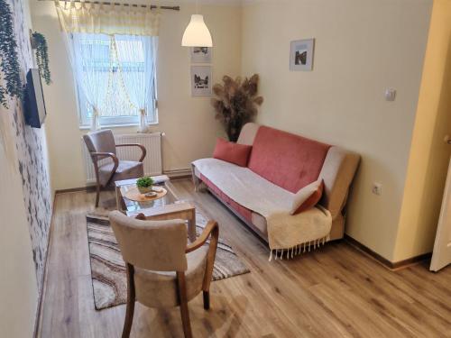 a living room with a couch and a table at Ravana Sky Apartments in Ivanjica