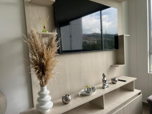 a living room with a vase and a window at Apartamento TERMINAL DE TRANSPORTE, CABLE AEREO, DOLLARCITY, D1 in Manizales