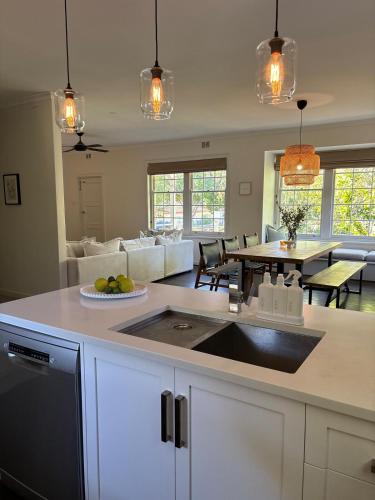 a kitchen and living room with a table and a counter at Casa thirty-six, 3BR, Central Location in Tanunda