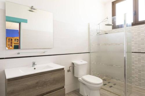 a bathroom with a toilet and a sink and a shower at S&C Apartments in Ilha da Madeira
