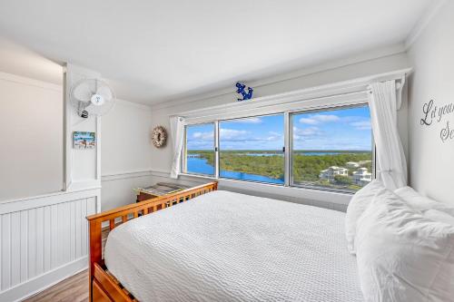 a bedroom with a bed and a large window at Stunning condo in Pinnacle Port, Panama City Beach in Panama City Beach