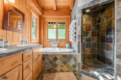 a bathroom with a tub and a sink and a shower at MHL Stevenson 97 in Stevenson