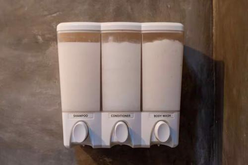 a row of coffee pots hanging on a wall at Sayula HoME in Sayulita