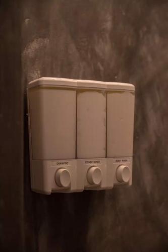 a soap dispenser on the side of a wall at Sayula HoME in Sayulita