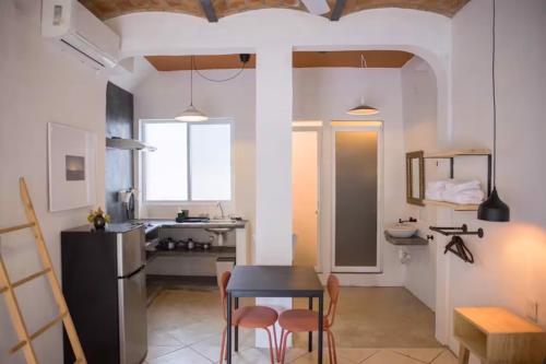 a kitchen with a table and chairs in a room at Sayula HoME in Sayulita