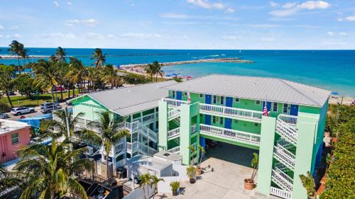 an aerial view of a building next to the ocean at Oceanfront Inn Room #15- Inlet View- King Bed in Fort Pierce
