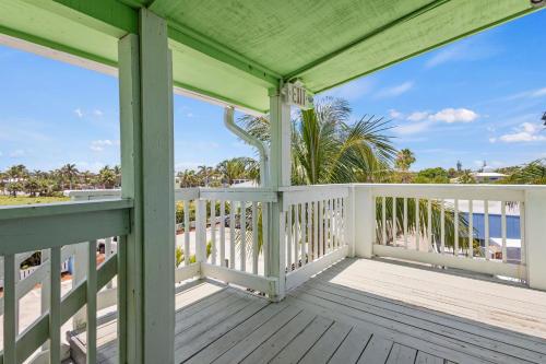 a porch with a view of the beach and the ocean at Oceanfront Inn Suite in Fort Pierce