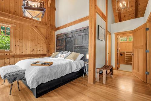 a bedroom with a bed in a room with wooden walls at M-Hill Lodge Stevenson 98 in Stevenson