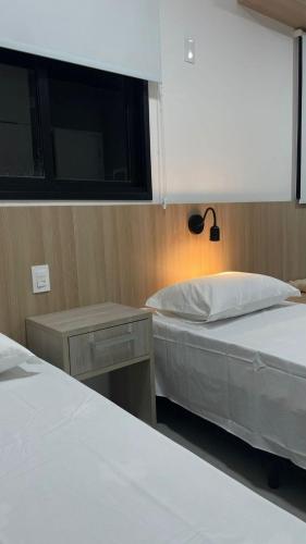 Ένα ή περισσότερα κρεβάτια σε δωμάτιο στο Apartamento Completo com Piscina, Academia e Salão de festas em São Carlos