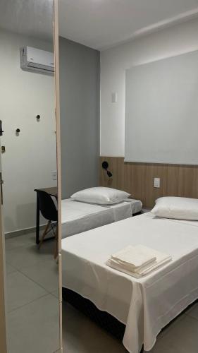 Ένα ή περισσότερα κρεβάτια σε δωμάτιο στο Apartamento Completo com Piscina, Academia e Salão de festas em São Carlos