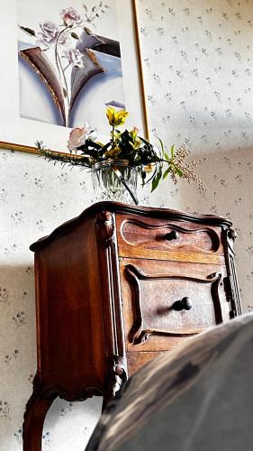 a wooden stove with flowers on top of it at 'Les Comètes' B&B in La Caujonnet