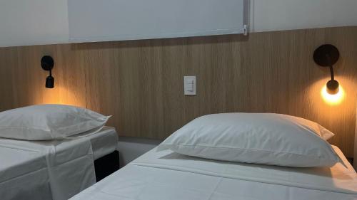 Ένα ή περισσότερα κρεβάτια σε δωμάτιο στο Apartamento Completo com Piscina, Academia e Salão de festas em São Carlos