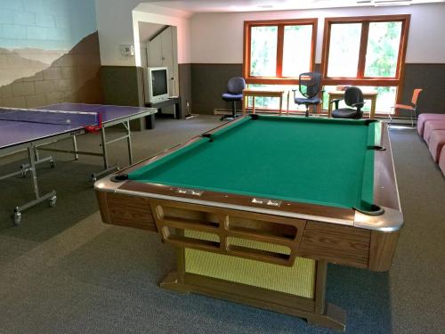 a room with a pool table and two tables at Snowater Condo 45SW with a Media Room in Deming