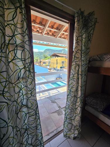 a room with a window with a view of a pool at Hostel ABC in Angra dos Reis