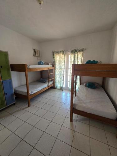 a room with two bunk beds and a window at Hostel ABC in Angra dos Reis