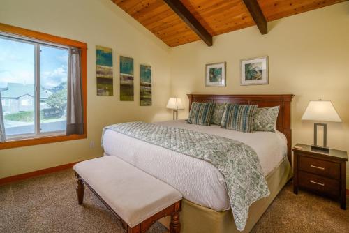 a bedroom with a large bed and a window at Pacific House in Cannon Beach